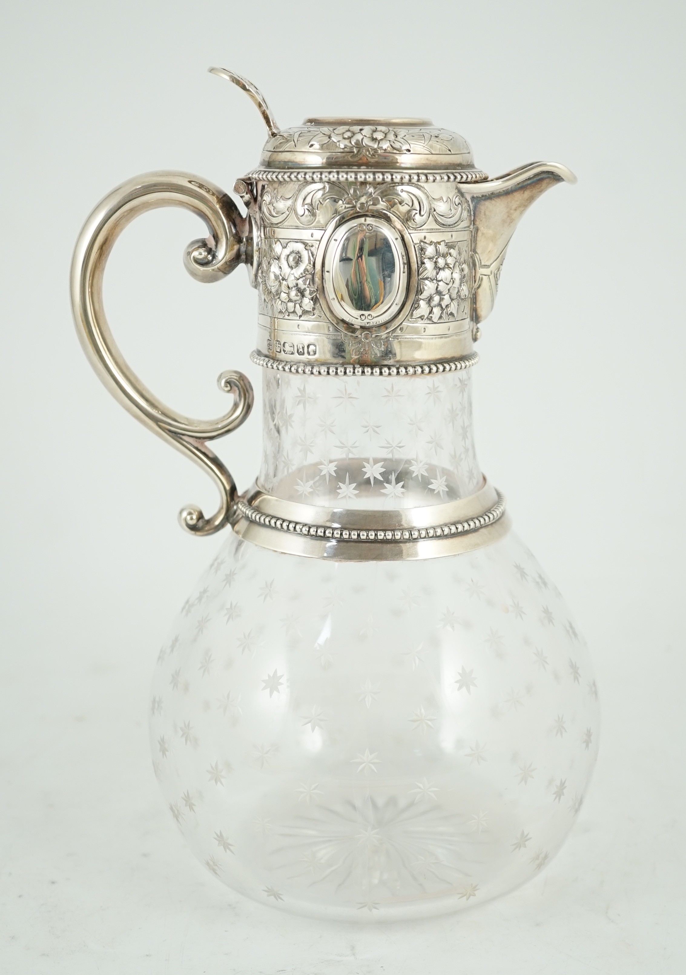 A Victorian embossed silver mounted engraved glass claret jug, the glass later, the silver, Sheffield, 1868, by William and George Sissons